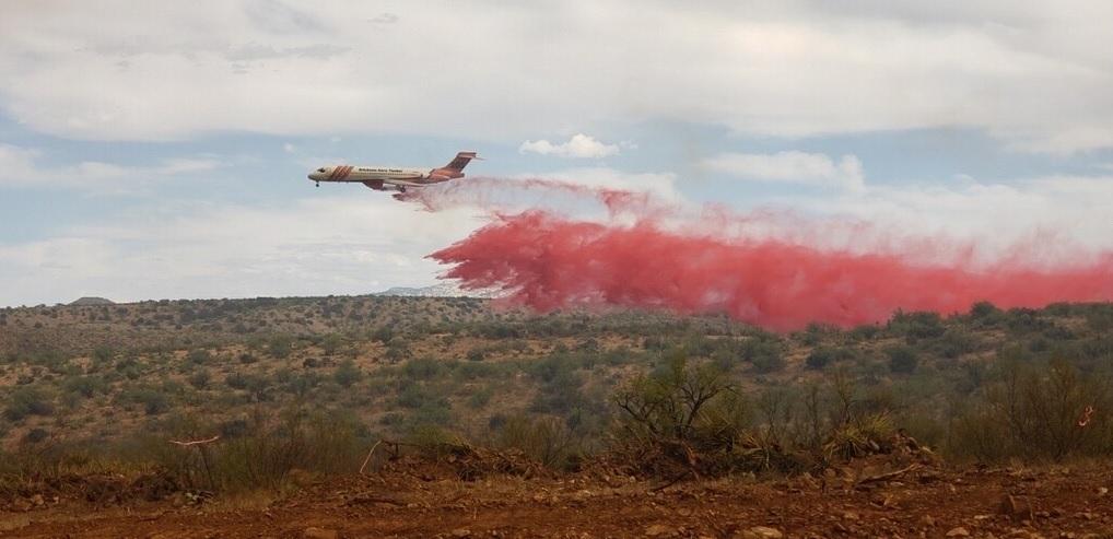 An air tanker drops fire retardant near the Bighorn Fire
