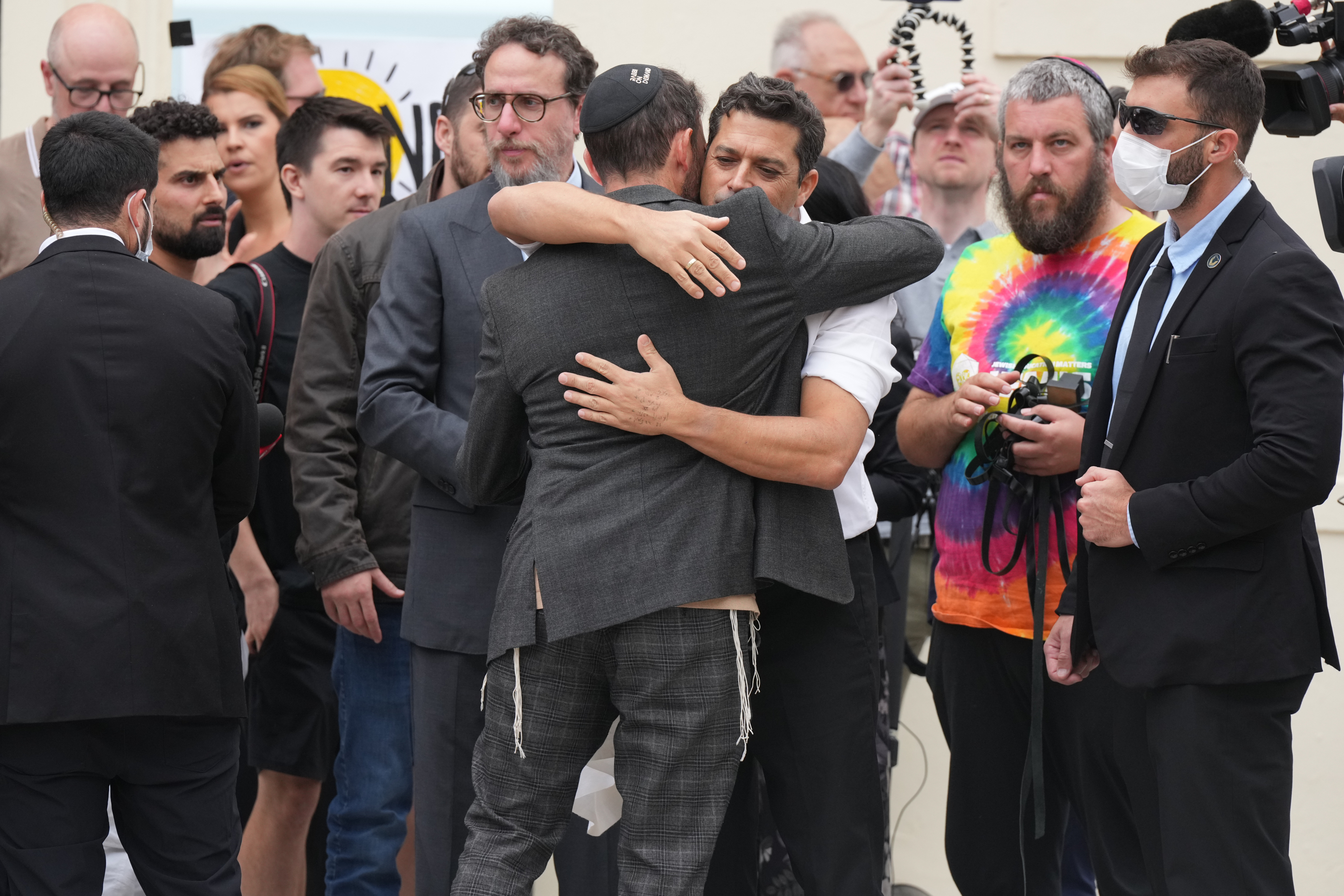Israel's Minister for Diaspora Affairs Amichai Chikli is embraced by a Rabbi at a floral tribute near the Bondi Pavilion at Bondi Beach on Tuesday, Dec. 16, 2025, following Sunday's shooting in Sydney, Australia. 