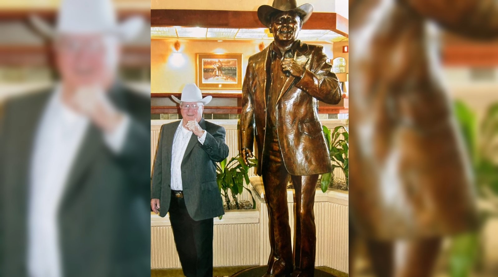 Lonnie Bell next to his statue in the Yellowstone Museum