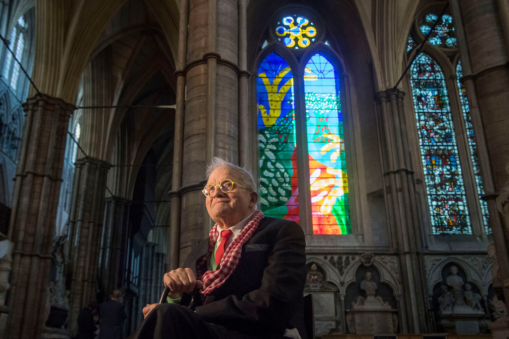 FILE - British artist David Hockney sits in front of The Queen's Window, a new stained glass window at Westminster Abbey, London, designed by David Hockney and revealed for the first time on Wednesday Sept. 26, 2018. 