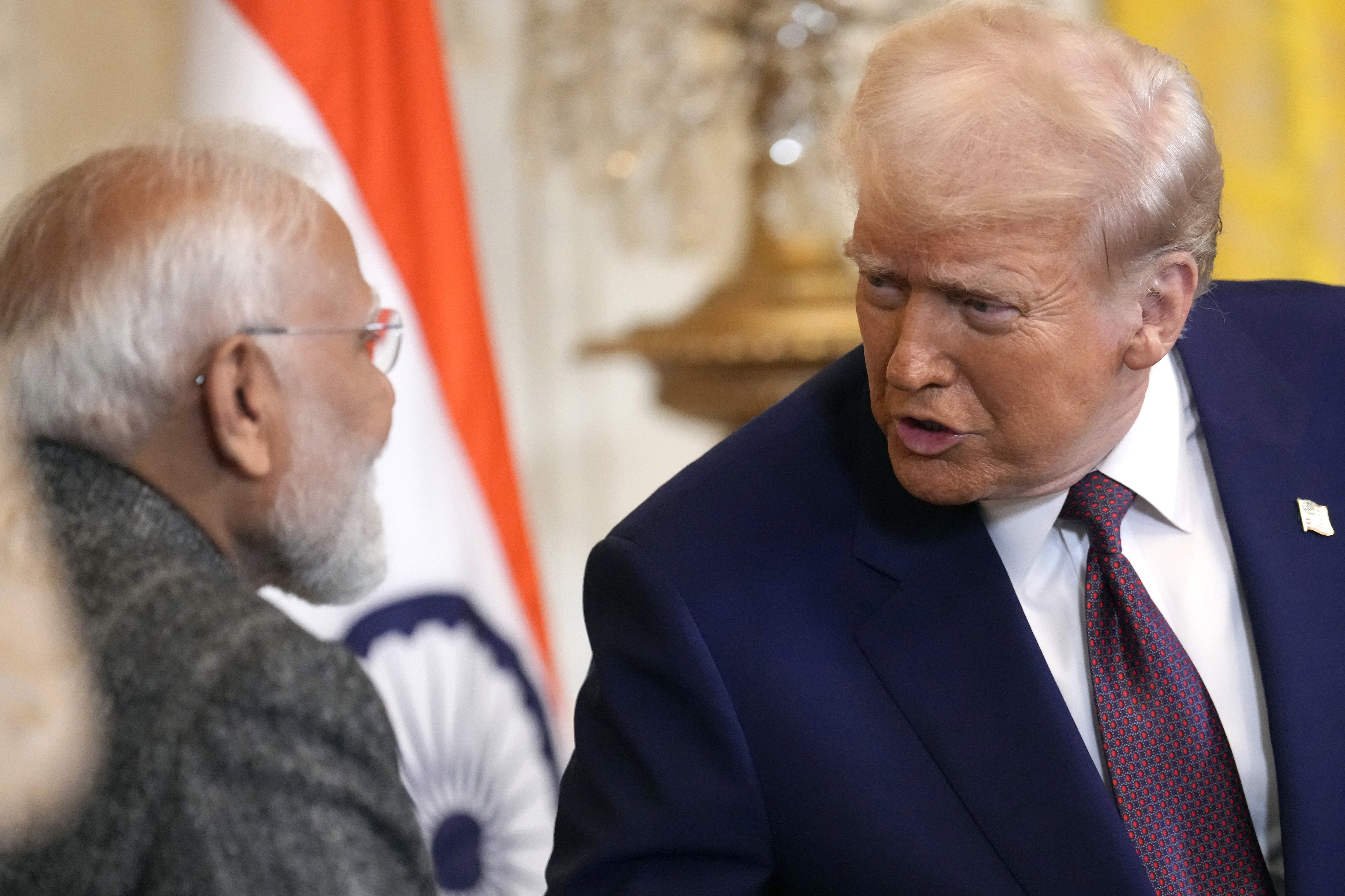 President Donald Trump, right, speaks with India's Prime Minister Narendra Modi during a news conference in the East Room of the White House, Feb. 13, 2025, in Washington.