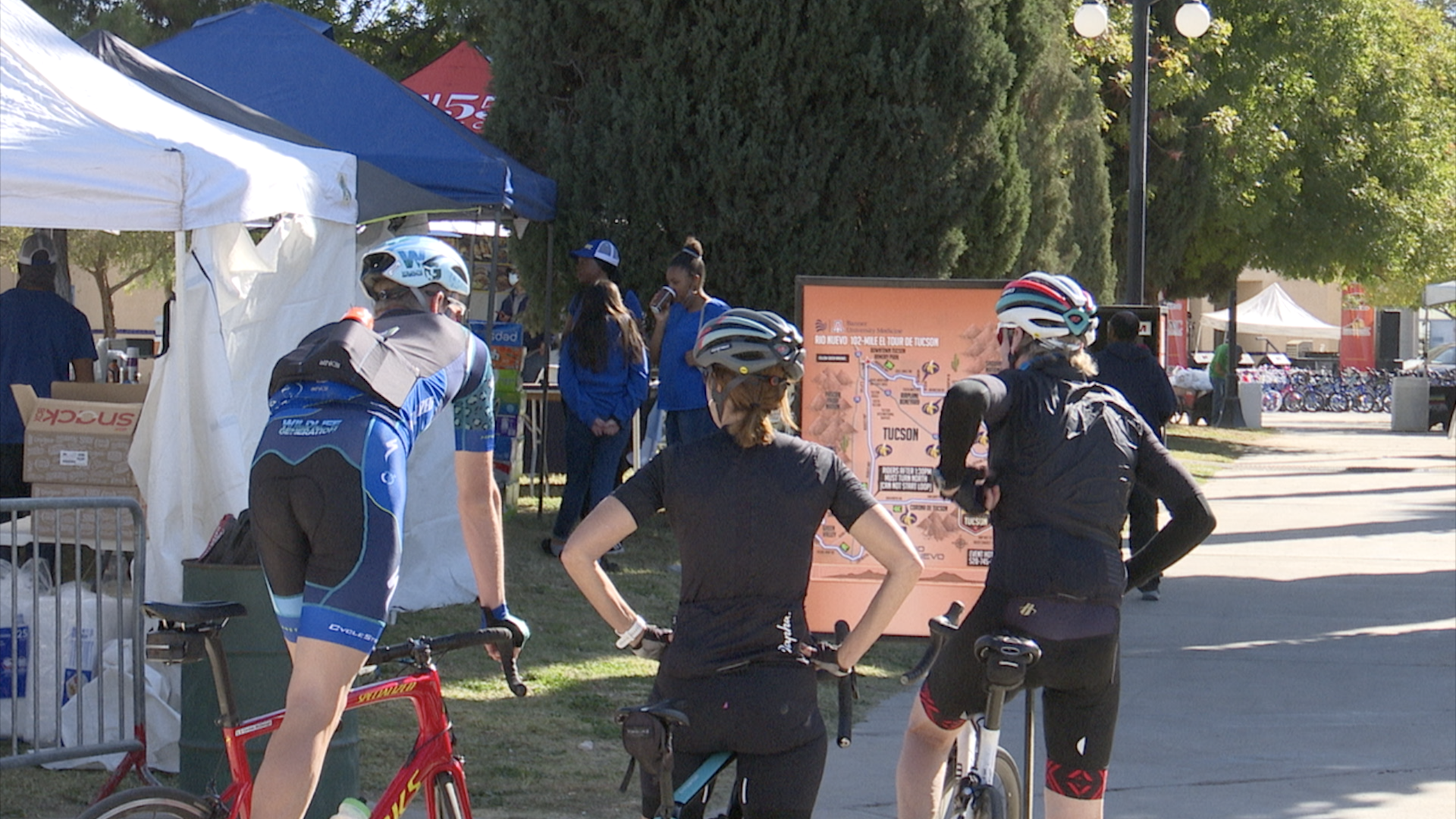 Riders examine the 102-mile route map at Armory Park on Friday ahead of El Tour de Tucson's return on Saturday. 