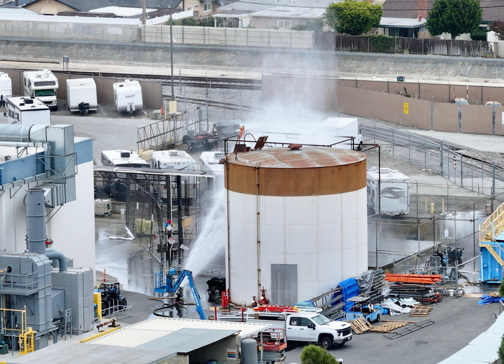 Water is sprayed on a tank that overheated at an aerospace plant in Garden Grove, Calif., Friday, May 22, 2026.  
