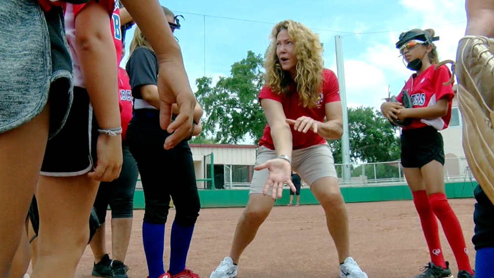 Michelle Smith teaching softball to girls