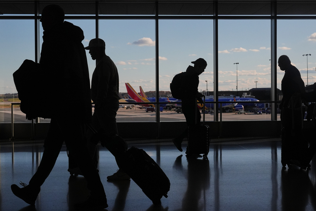 Southwest Airlines planes sit at gates as travelers walk through Baltimore/Washington International Thurgood Marshall Airport.