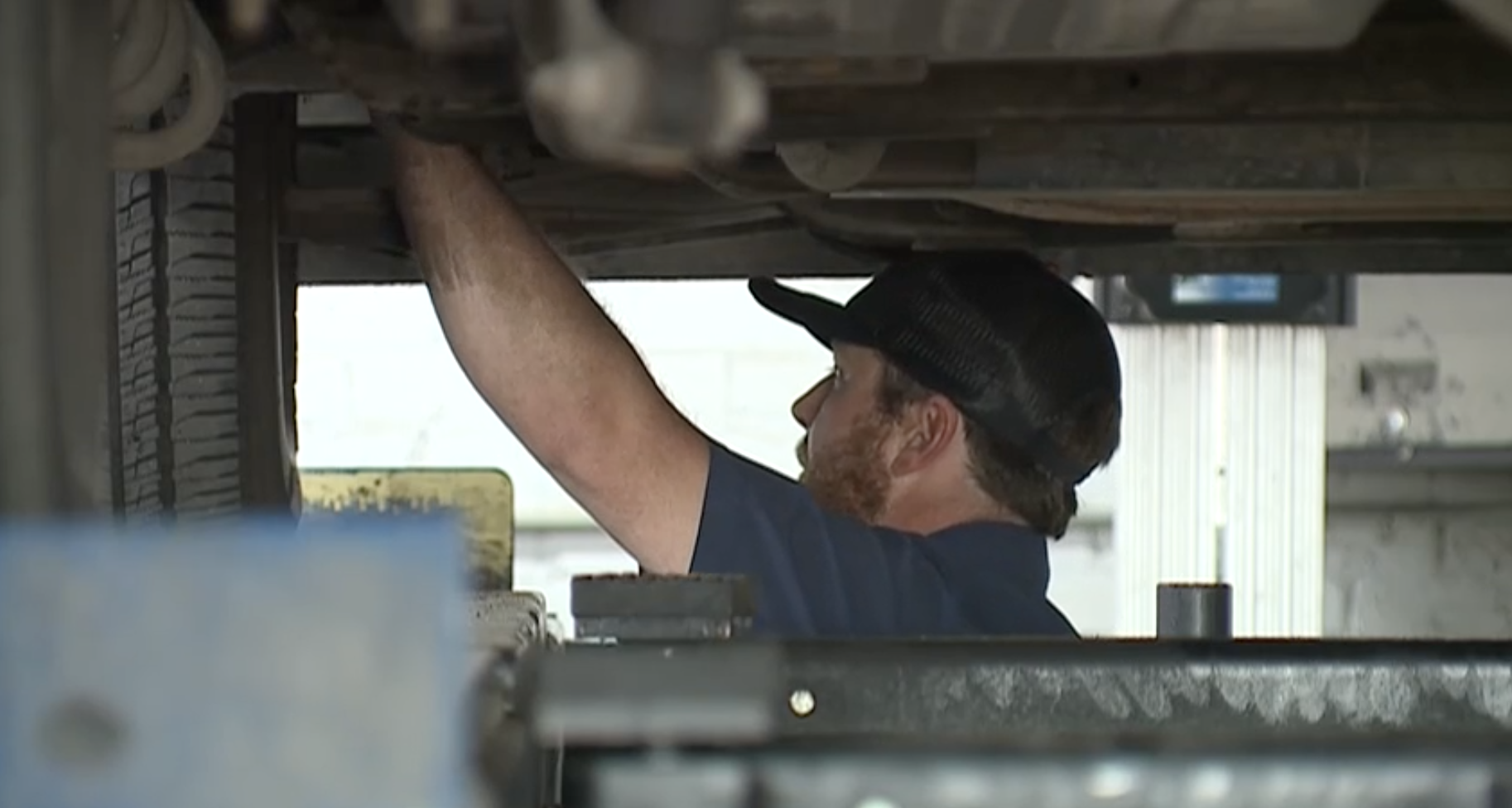 Mechanic working on a car.