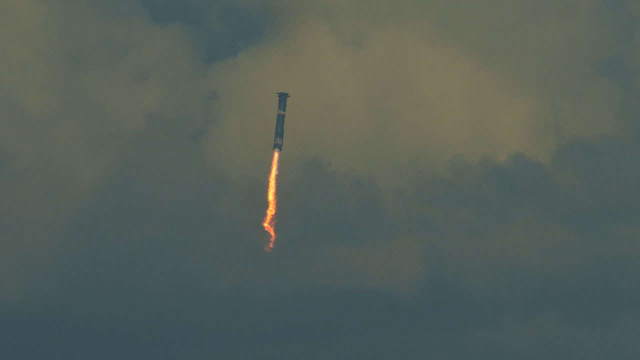 SpaceX's mega rocket booster returns to the gulf during a test flight from Starbase, Texas, Monday, Oct. 13, 2025. (AP Photo/Eric Gay)