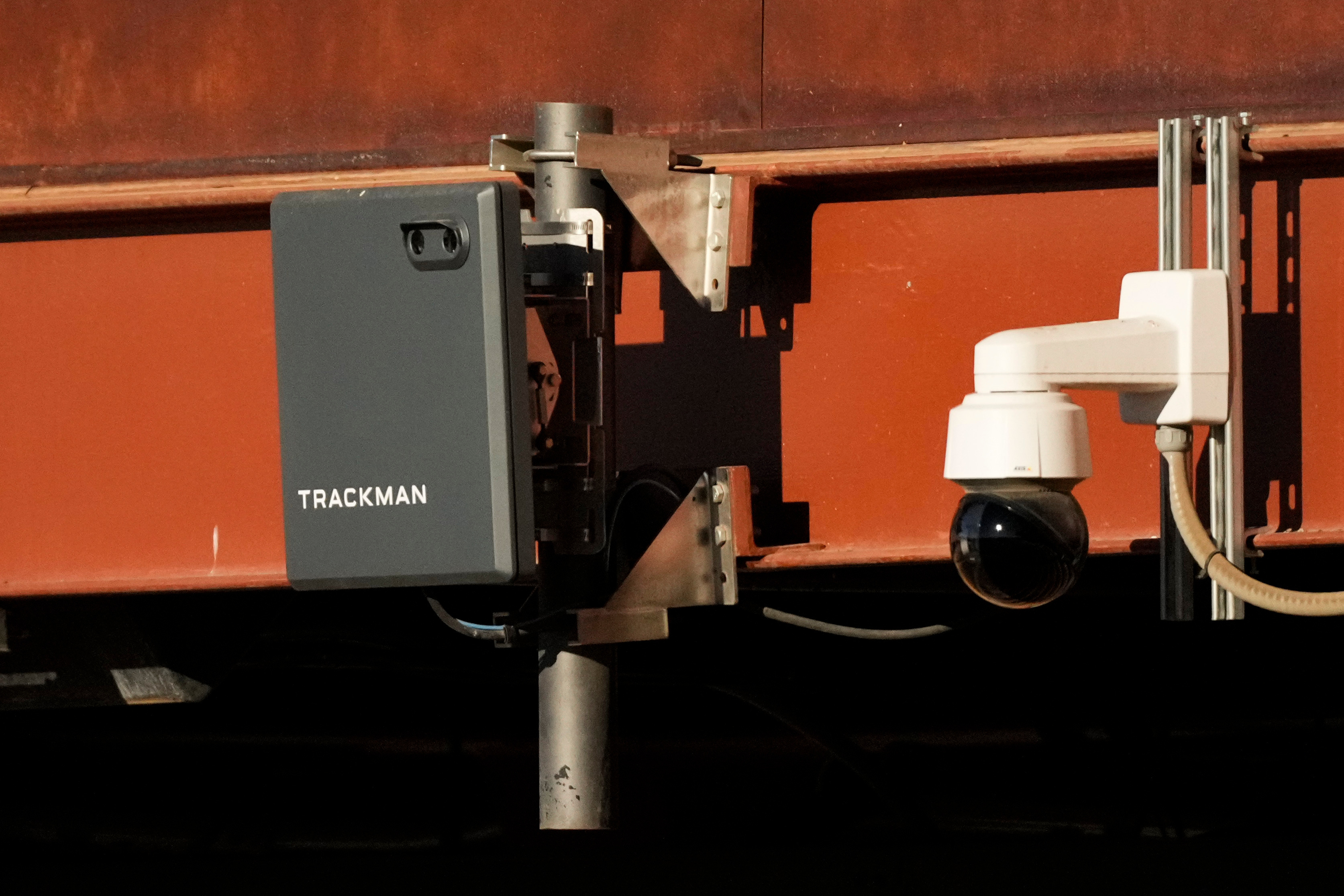 FILE - A Trackman device used for the Automated Ball-Strike System is posted on the balcony behind home plate before a spring training baseball game between the Kansas City Royals and the Los Angeles Dodgers, Saturday, Feb. 22, 2025, in Phoenix. (AP Photo/Ashley Landis, file)