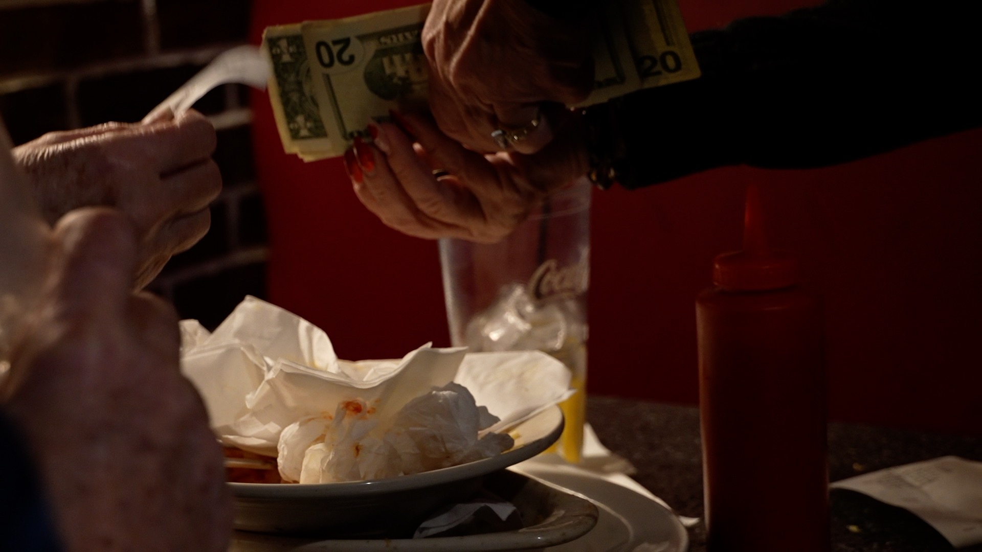 Server at Tony M's grabs payment and tip