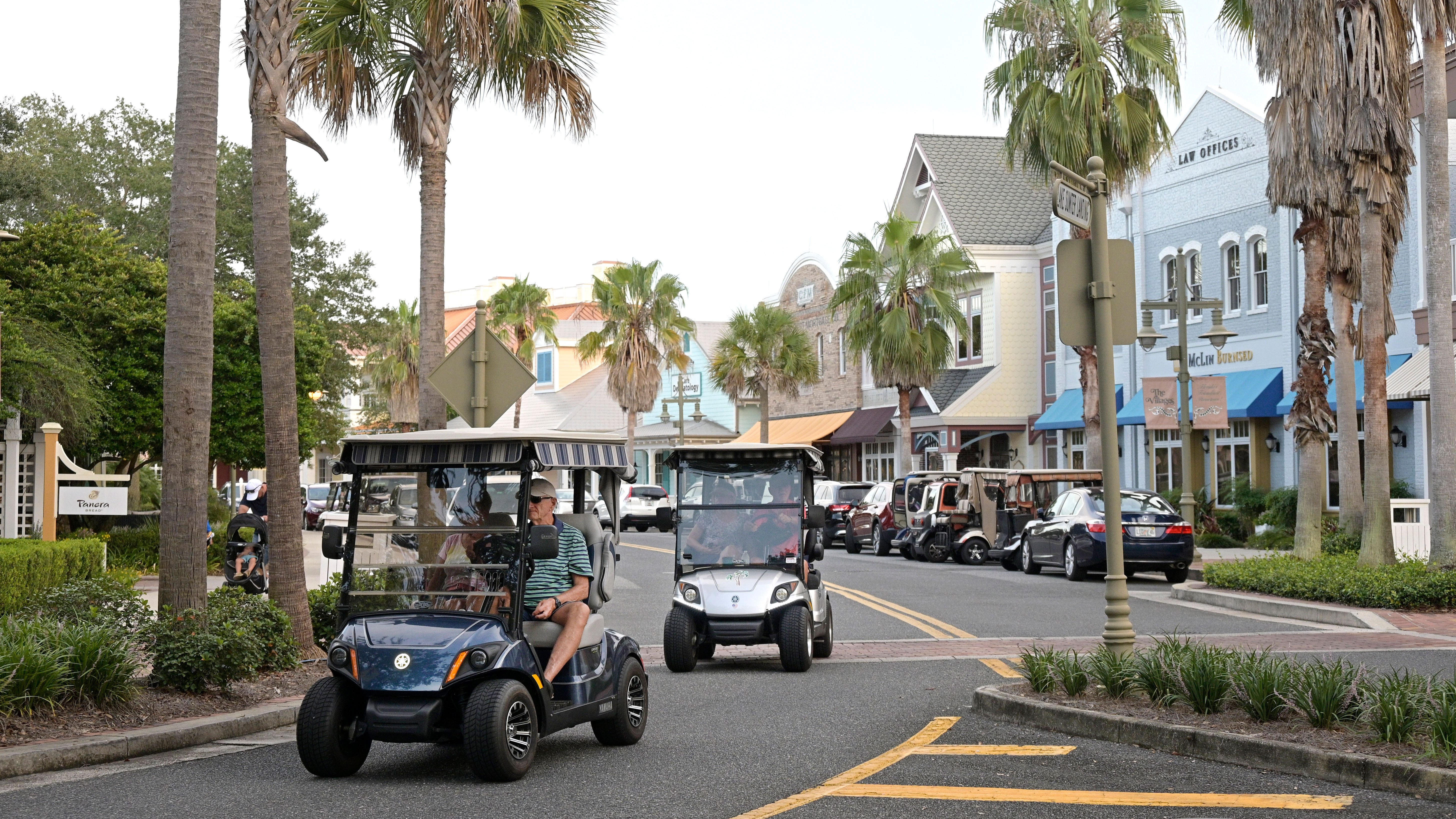 Residents drive golf carts through the Lake Sumter Landing Market Square on Aug. 12, 2021, in The Villages, Fla. A 77-year-old man in Florida has been arrested on a federal charge for obtaining misbranded erectile dysfunction drugs with the intent of distributing the medications throughout the enormous retirement community where he lives and elsewhere, authorities said. The man was arrested Sept. 2023, in The Villages, the sprawling retirement community of almost 80,000 full-time residents in central Florida.