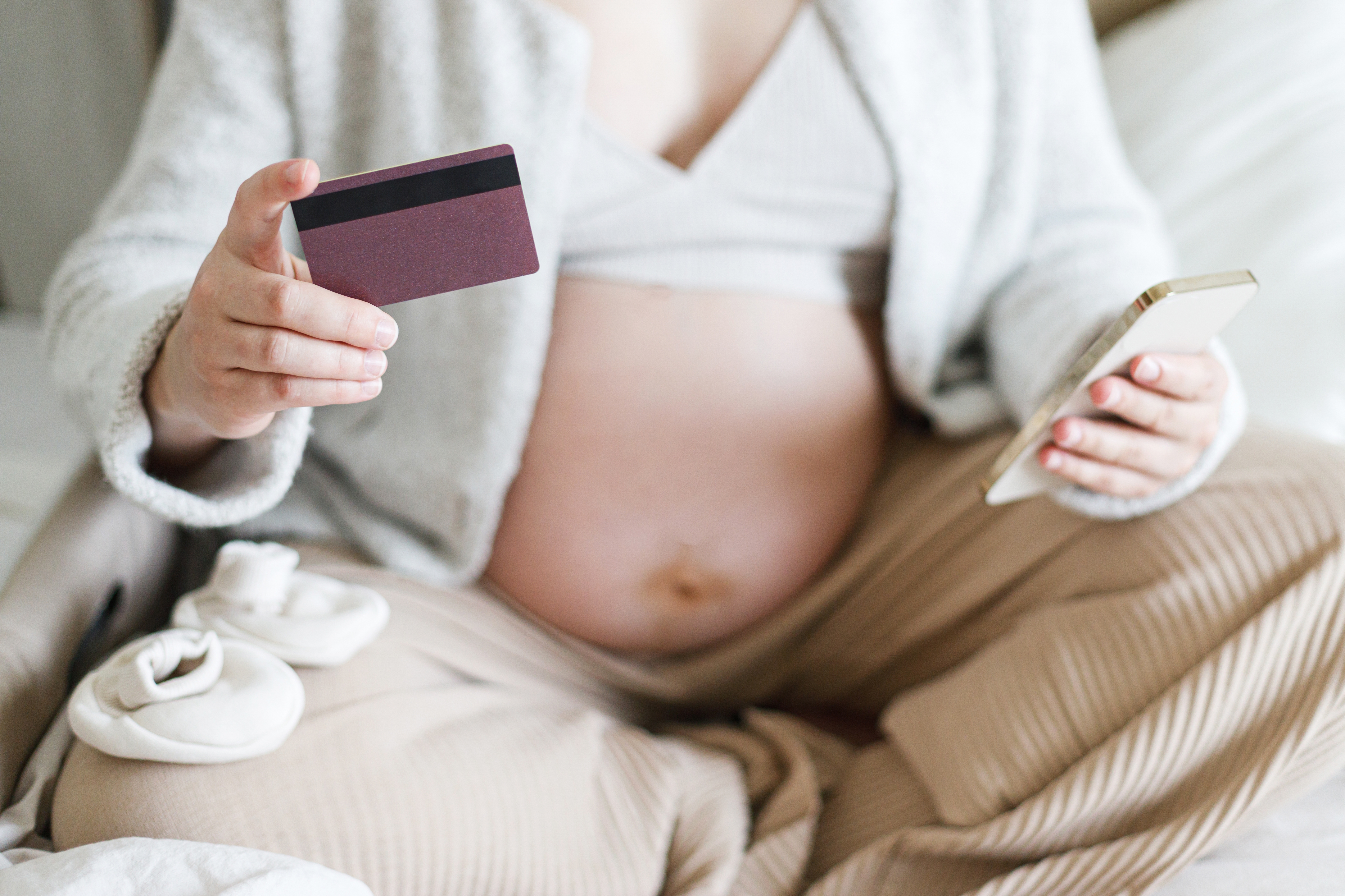 A pregnant woman buying products.