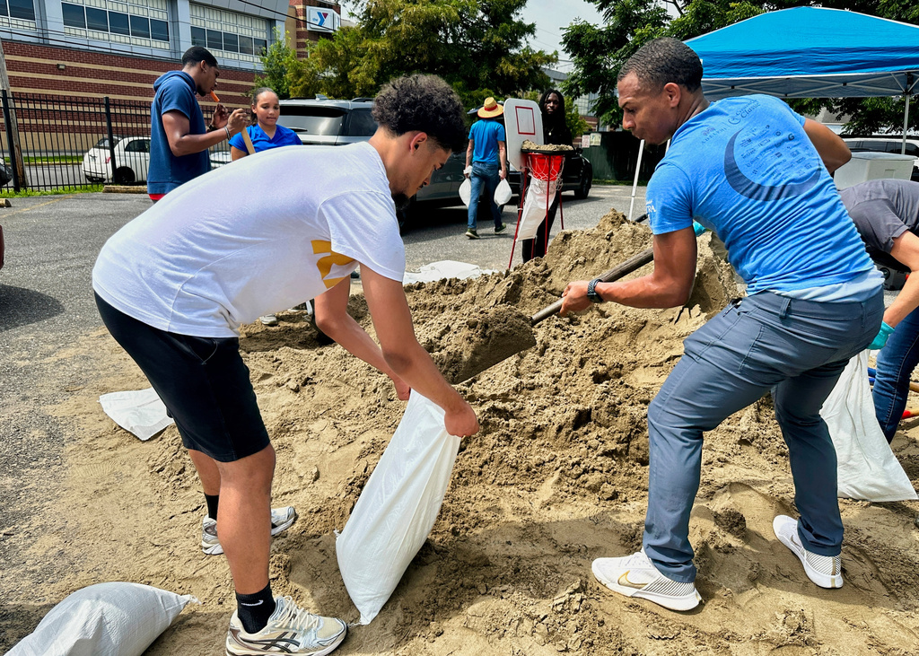 Volunteers fill sandbags for New Orleans residents, Wednesday, July 16, 2025, anticipating heavy rain from a tropical weather system moving toward the Gulf Coast.