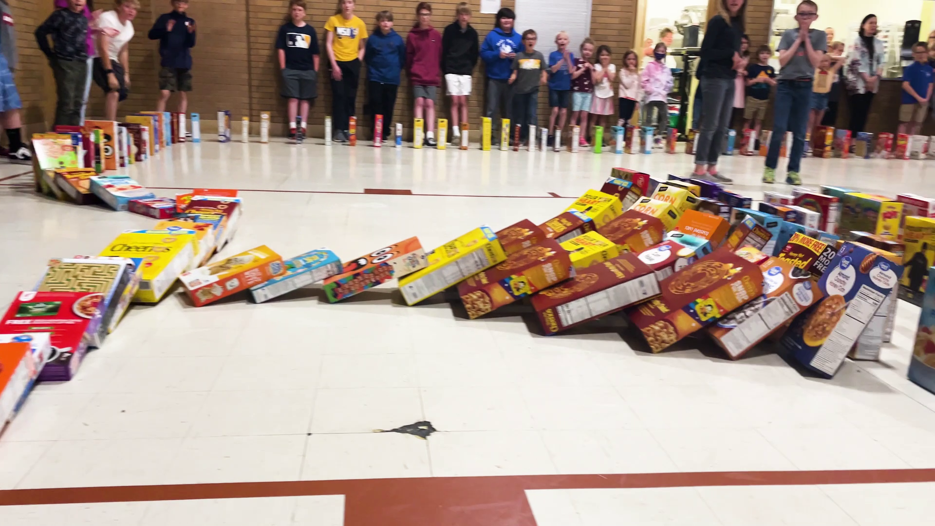 Great Falls students do a 'domino run' before donating cereal