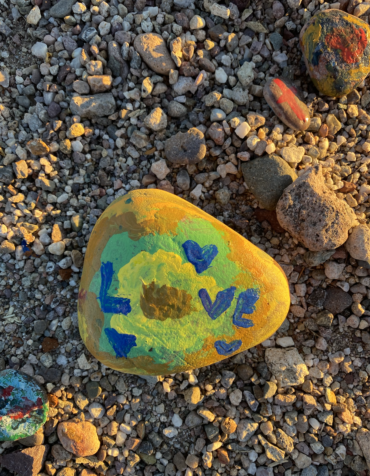 Rocks painted by family and delivered to neighbors to uplift community