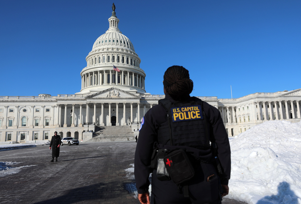 A U.S. Capitol Police officer patrols on the East Front of the U.S. Capitol after a snowstorm, Tuesday, Jan. 27, 2026, in Washington.