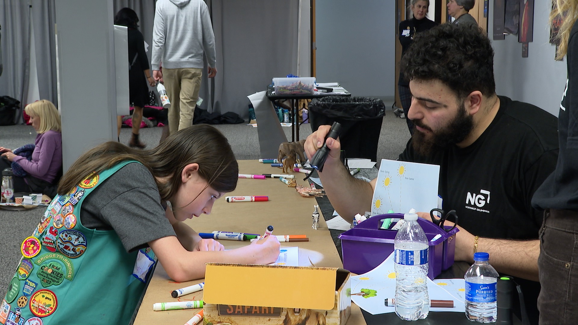 A girl scout learns about light and shadows during a space event