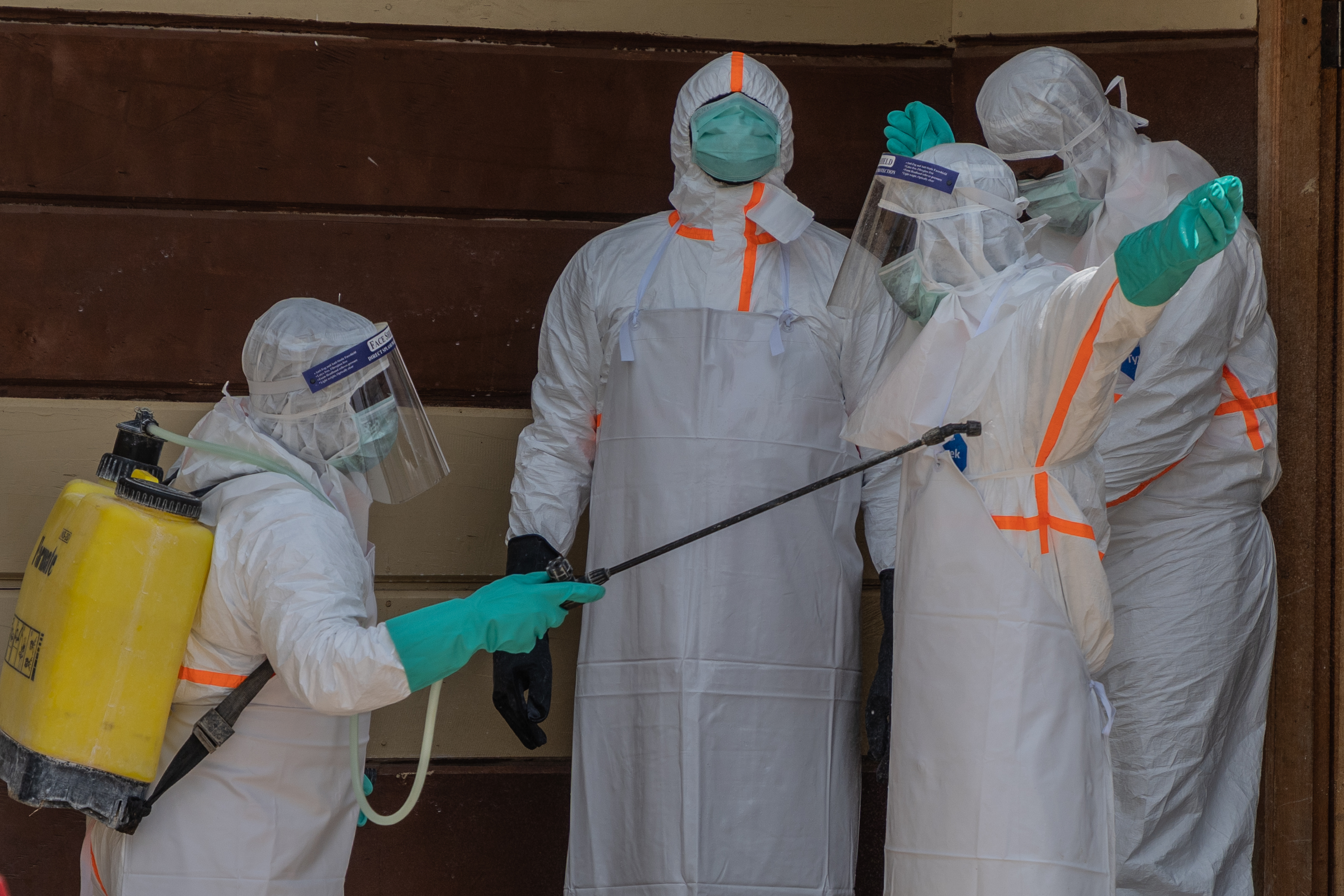 Health workers disinfect themselves after preparing the body of an Ebola victim at Citadelle Clinic in Bunia, Congo, Friday, June 12, 2026. 