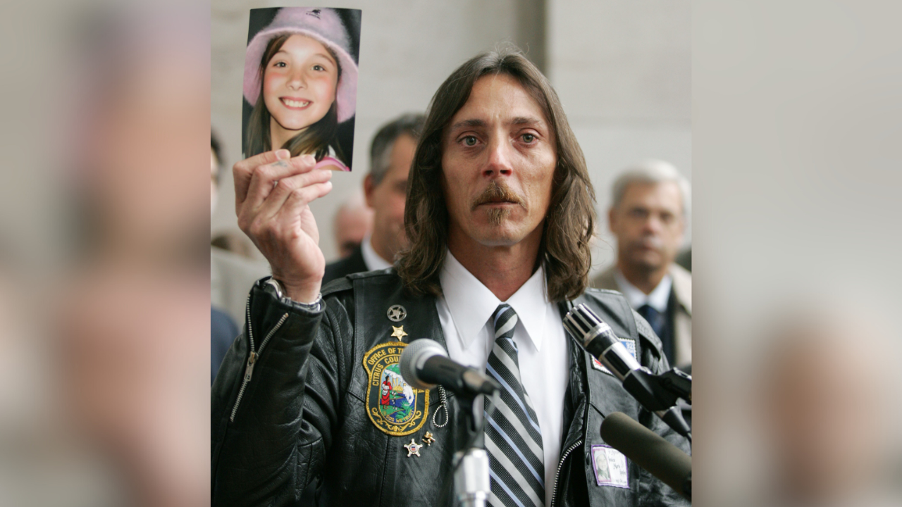 Mark Lunsford with photo of Jessica Lunsford
