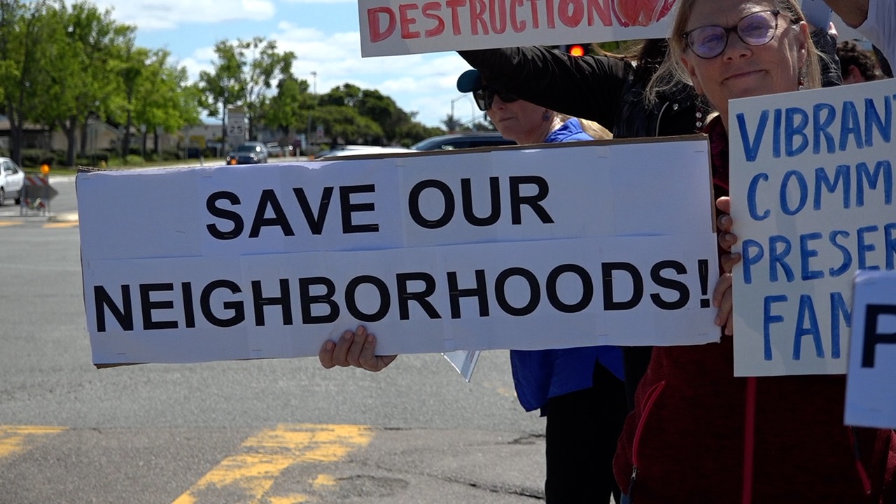 Protesters in University City hold signs opposing high-density housing