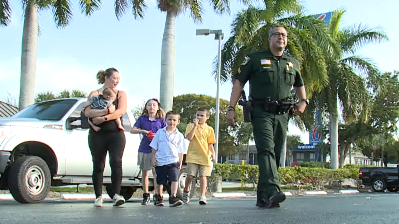 Palm Beach County Sheriff's Office Corporal Adrian Maldonado helps a homeless family, Nov. 17, 2022.jpg