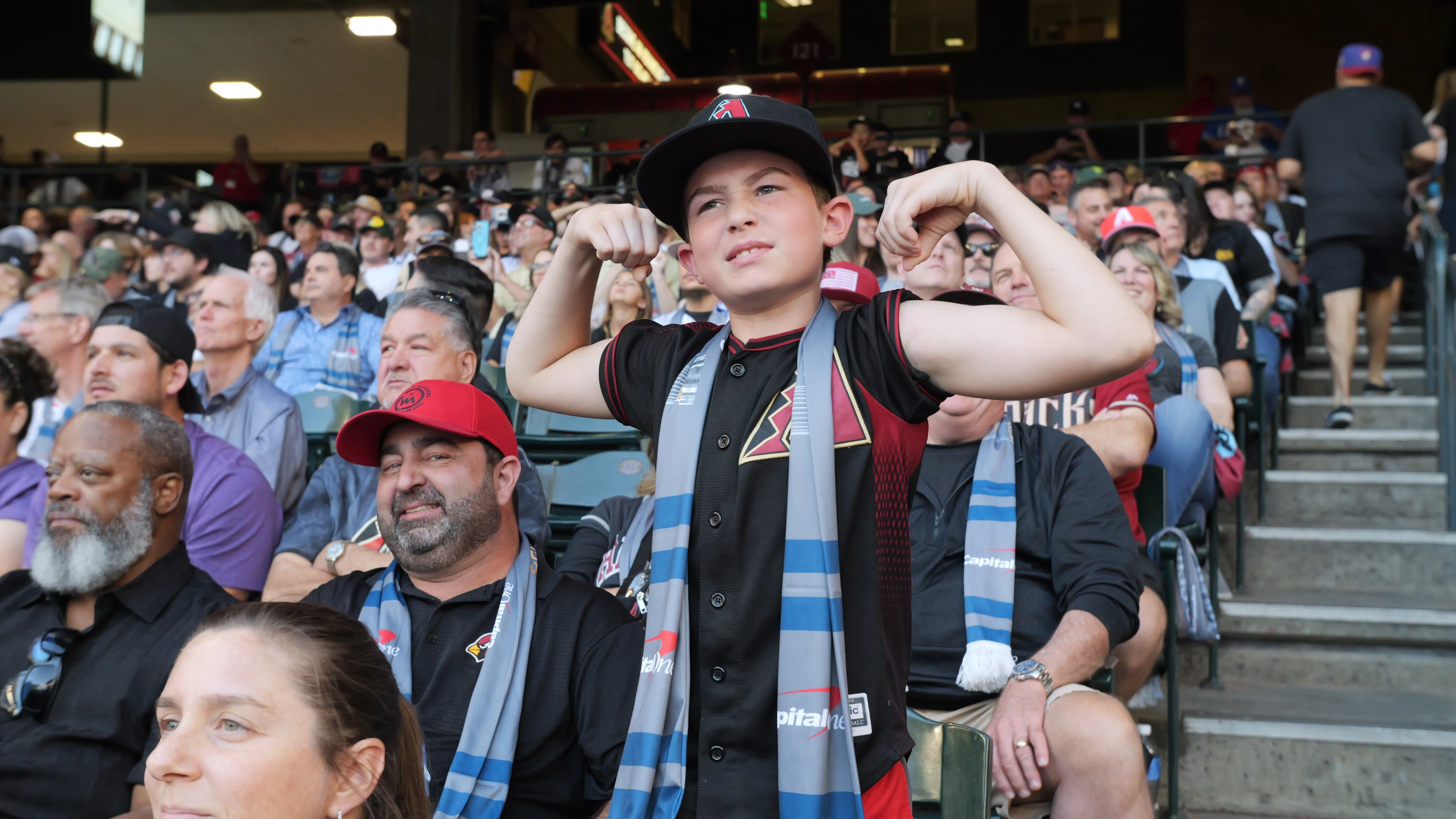 Young fan standing tall and proud for the D-backs as they faced the Rangers in a sold-out Chase Field for game 3 of the 2023 World Series.