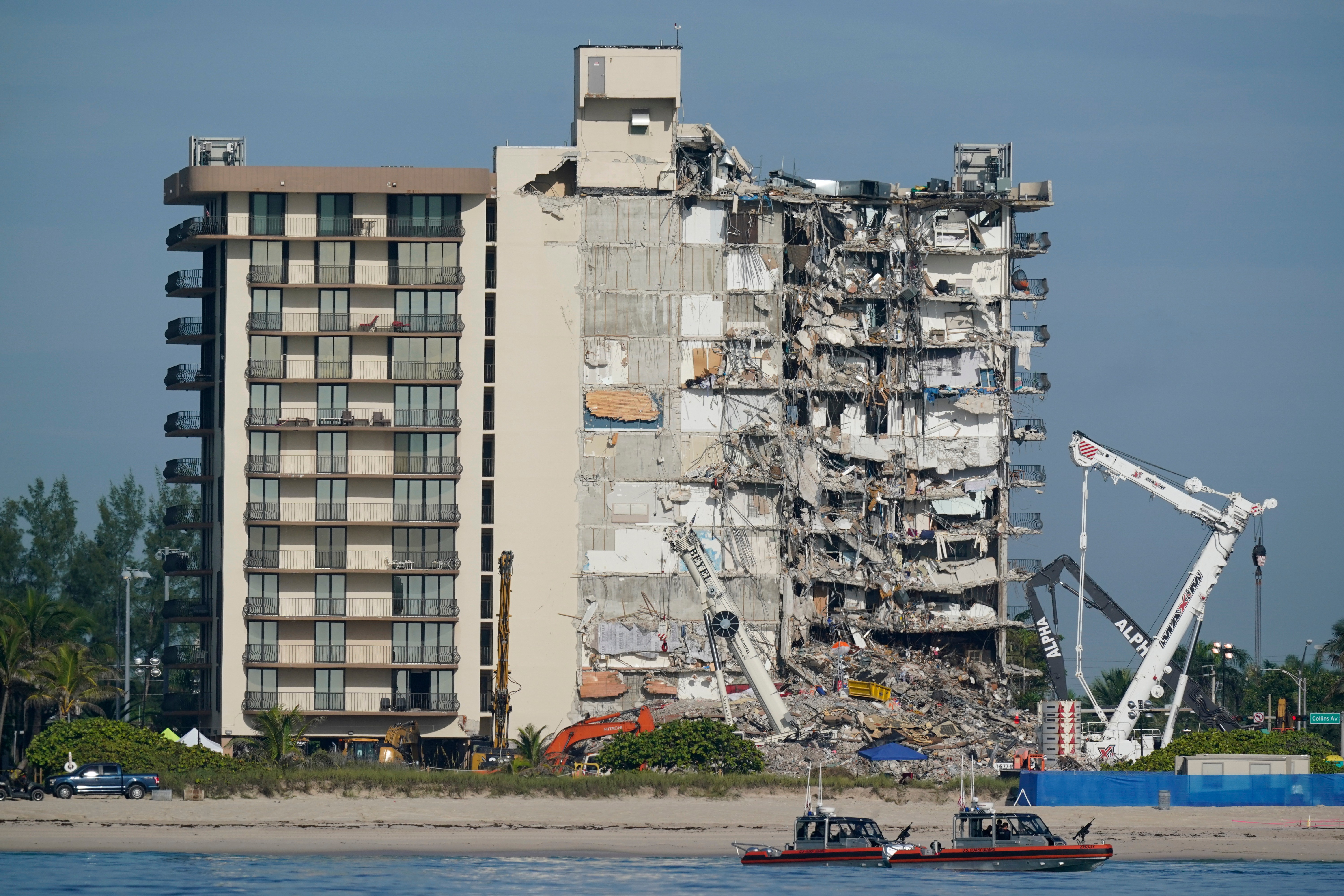 FILE - Coast Guard boats patrol in front of the partially collapsed Champlain Towers South condo building, July 1, 2021, in Surfside, Fla.