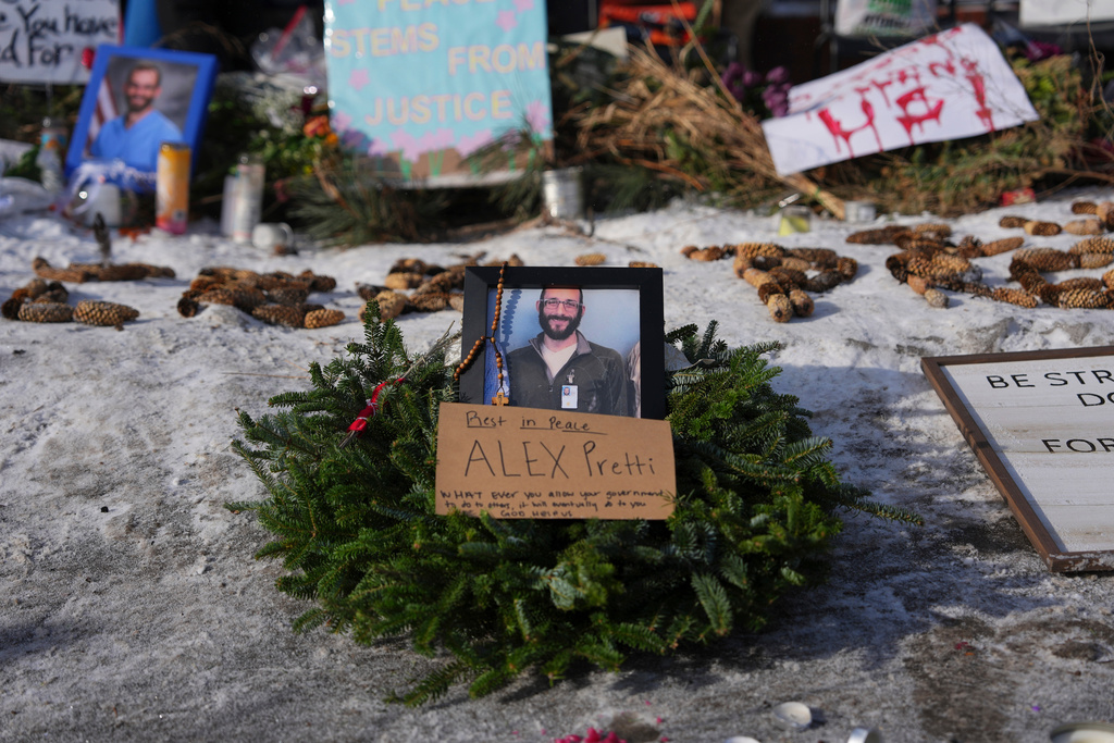 A makeshift memorial is placed where Alex Pretti was fatally shot by a U.S. Border Patrol officer yesterday, in Minneapolis, Sunday, Jan. 25, 2026. 