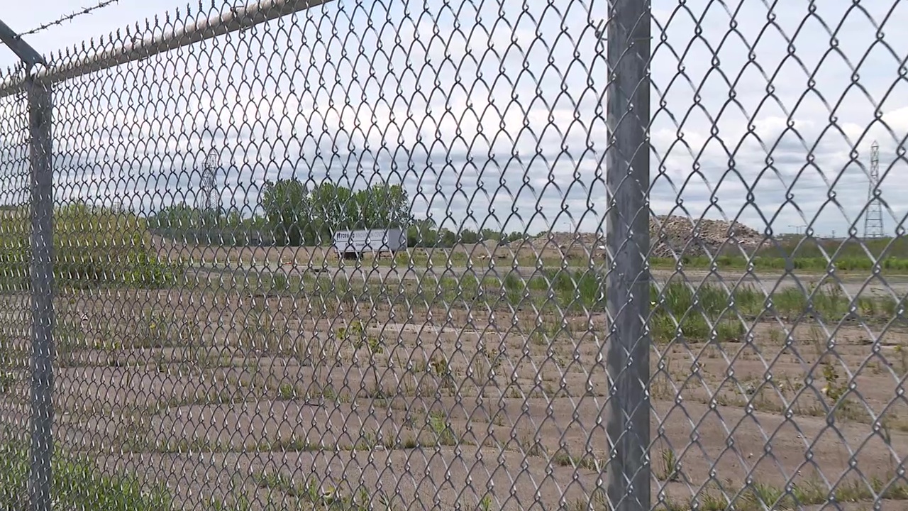A chain-link fence surrounds the 176-acre Brook Park property where Haslam Sports Group envisions a new sports and entertainment district, anchored by an enclosed stadium.