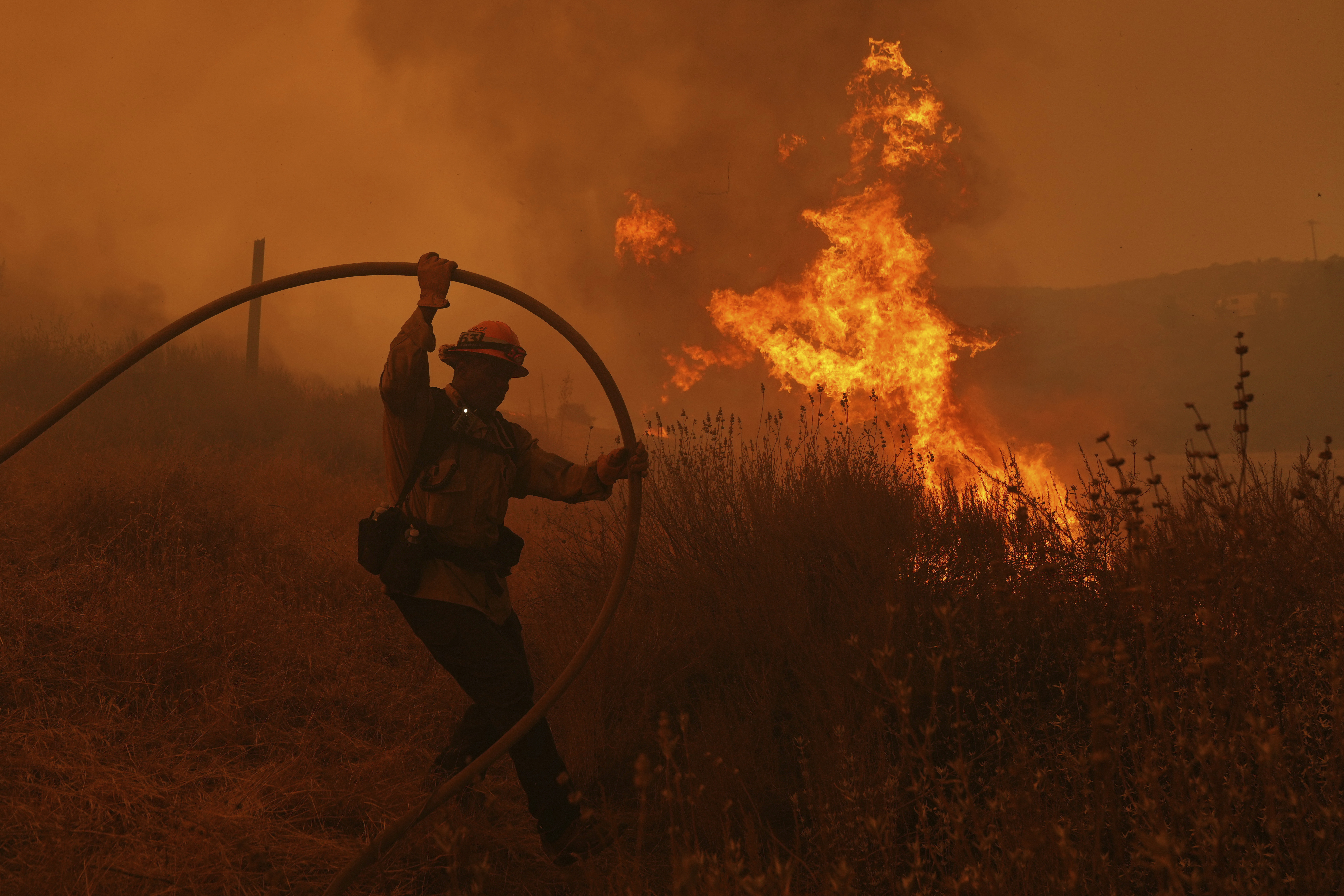 A firefighter battles the Canyon Fire on Thursday, Aug. 7, 2025, in Hasley Canyon, Calif. 