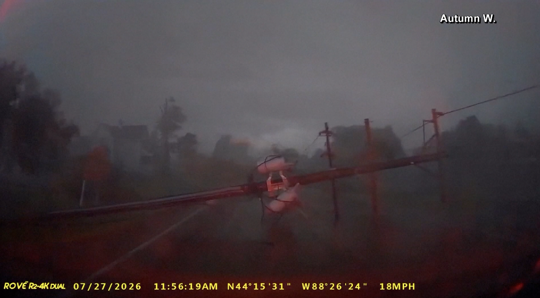 A screen grab from the viral video posted by Autumn Willette of the storm that caused the Fox Valley tornado showing a power line almost hitting her vehicle.