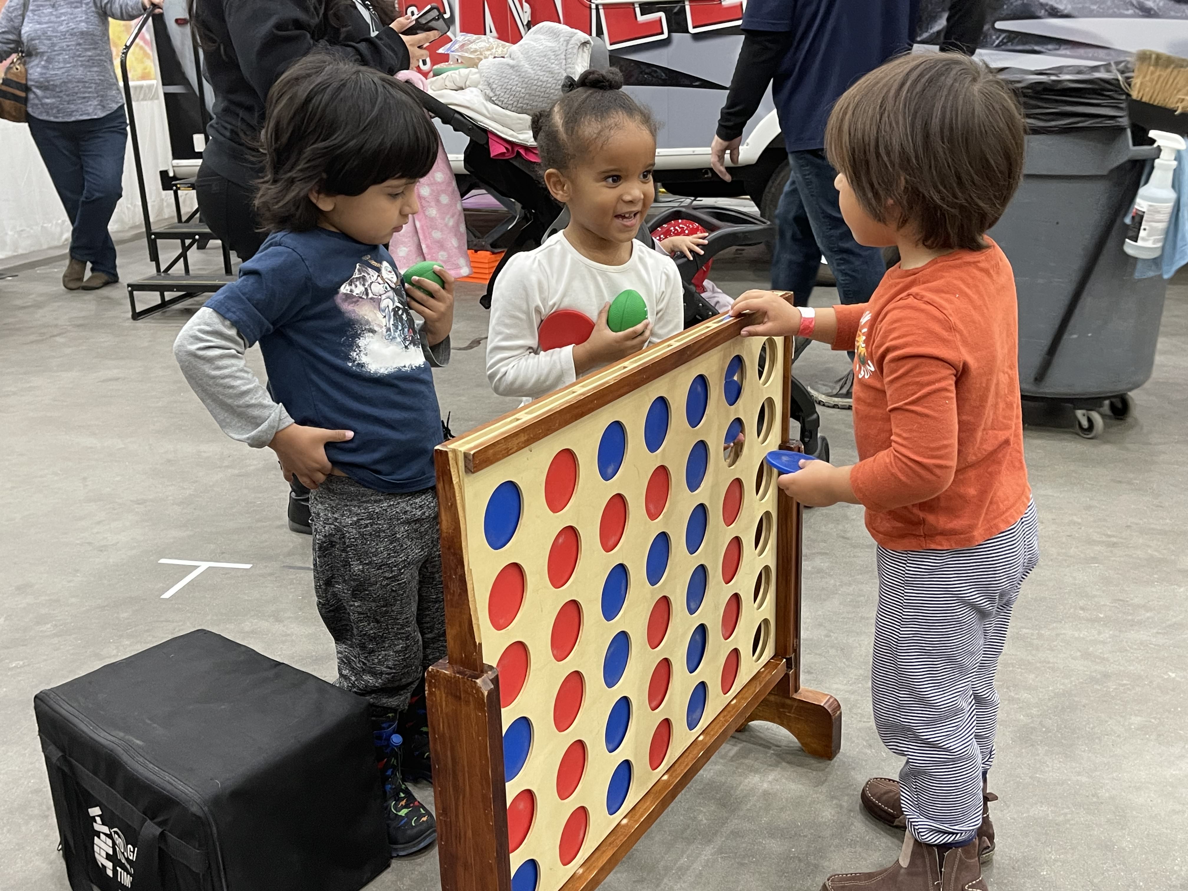 Kids playing giant Connect 4 at the Kids & Family Expo