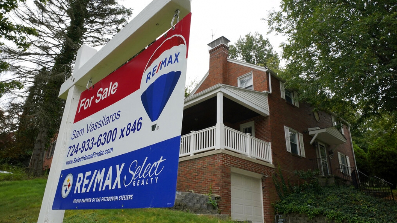 A for sale sign in front of a house