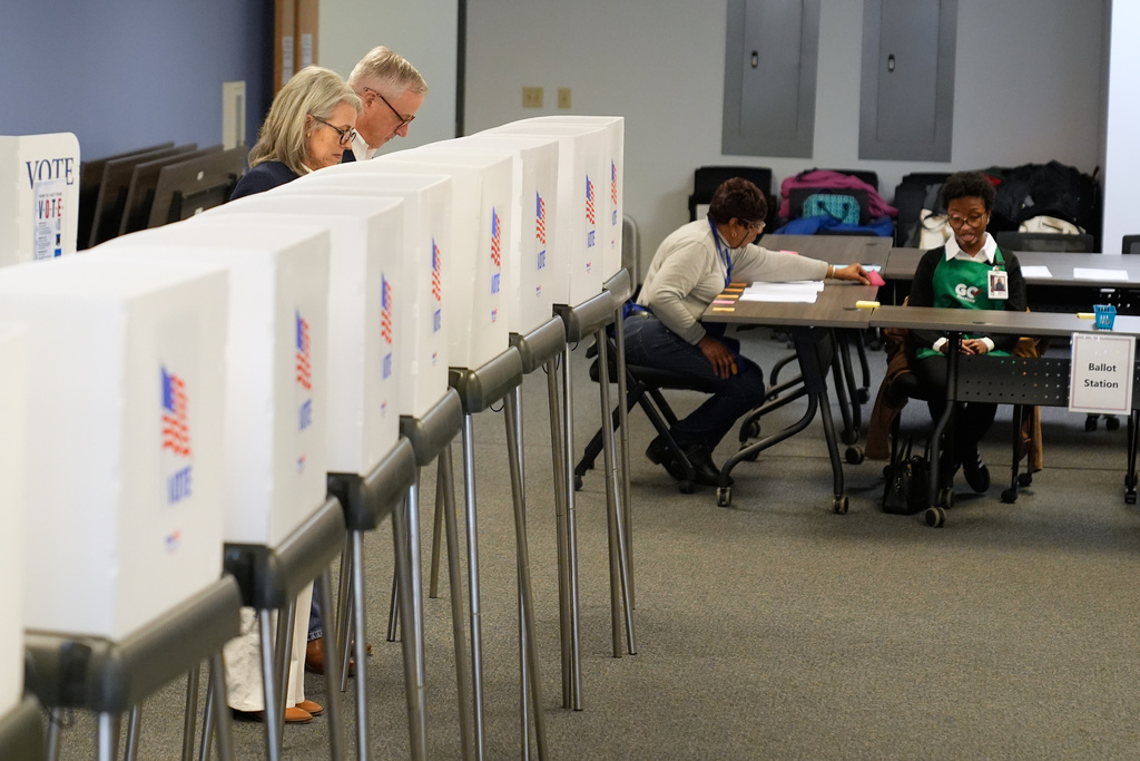 Republican U.S. Senate candidate Michael Whatley, second from left, and his wife Suzanne, left, cast their votes at an early voting site on Thursday, Feb. 12, 2026, in Gastonia, N.C. 