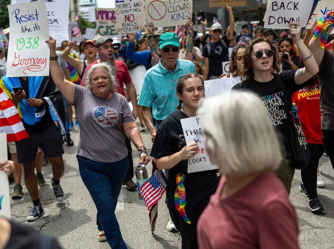 Beth Vaughan, center, chants as protesters march up Walker Street during a “No Kings” protest at Houston City Hall on June 14.