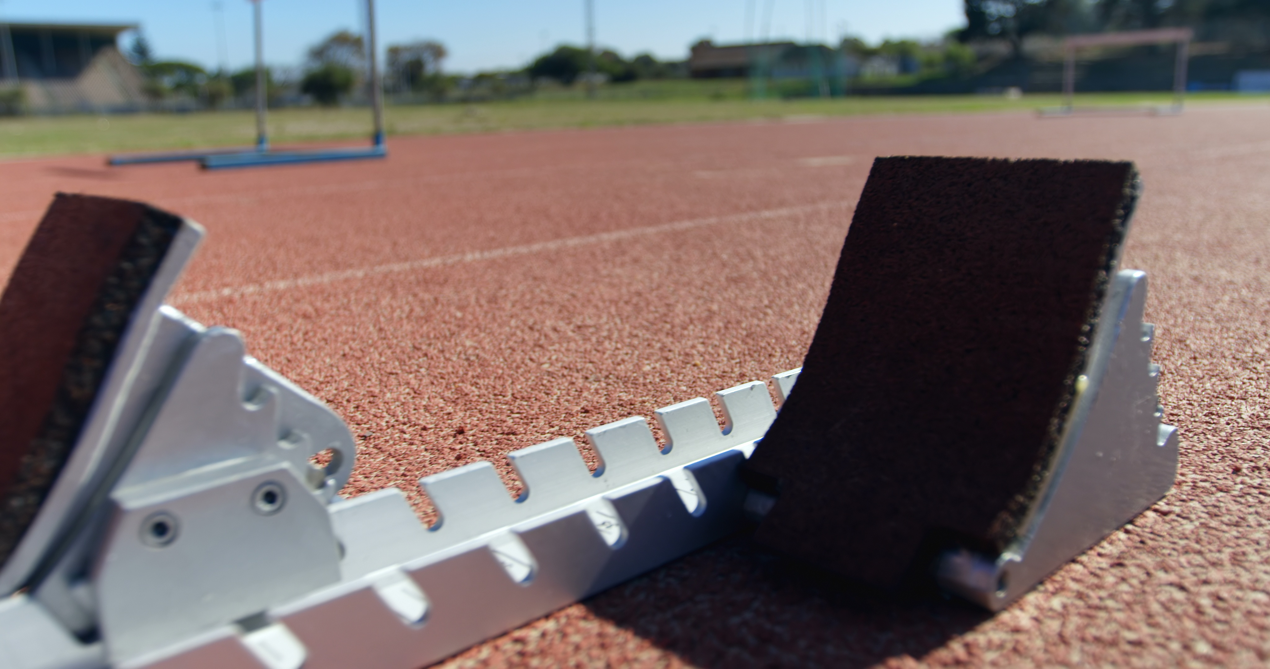 close-up-of-starting-blocks-on-a-running-track-4k-SBI-349506436.jpg