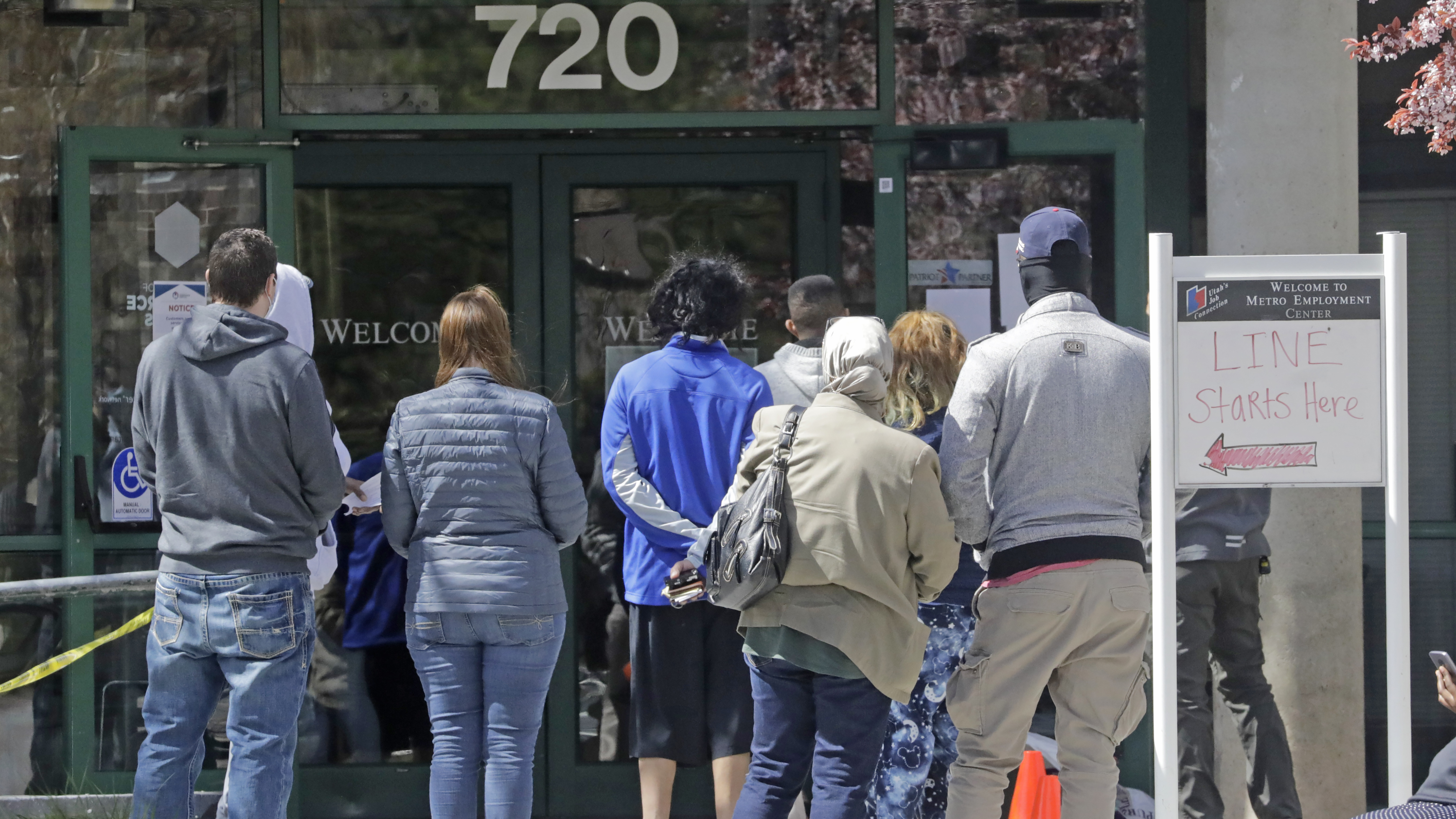 File photo: People line up outside the Utah Department of Workforce Services in Salt Lake City.