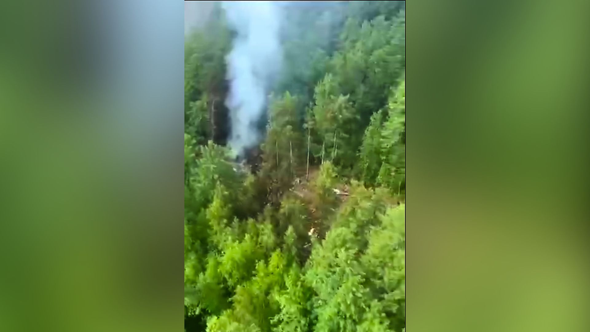 In this photo taken from video released by Russia Emergency Situations Ministry press service on Thursday, July 24, 2025, smoke rises from the crash site of a Russian An-24 passenger plane of the Siberia-based Angara Airlines about 15 kilometers (9 miles) south of Tynda, Far Eastern Amur region of Russia.