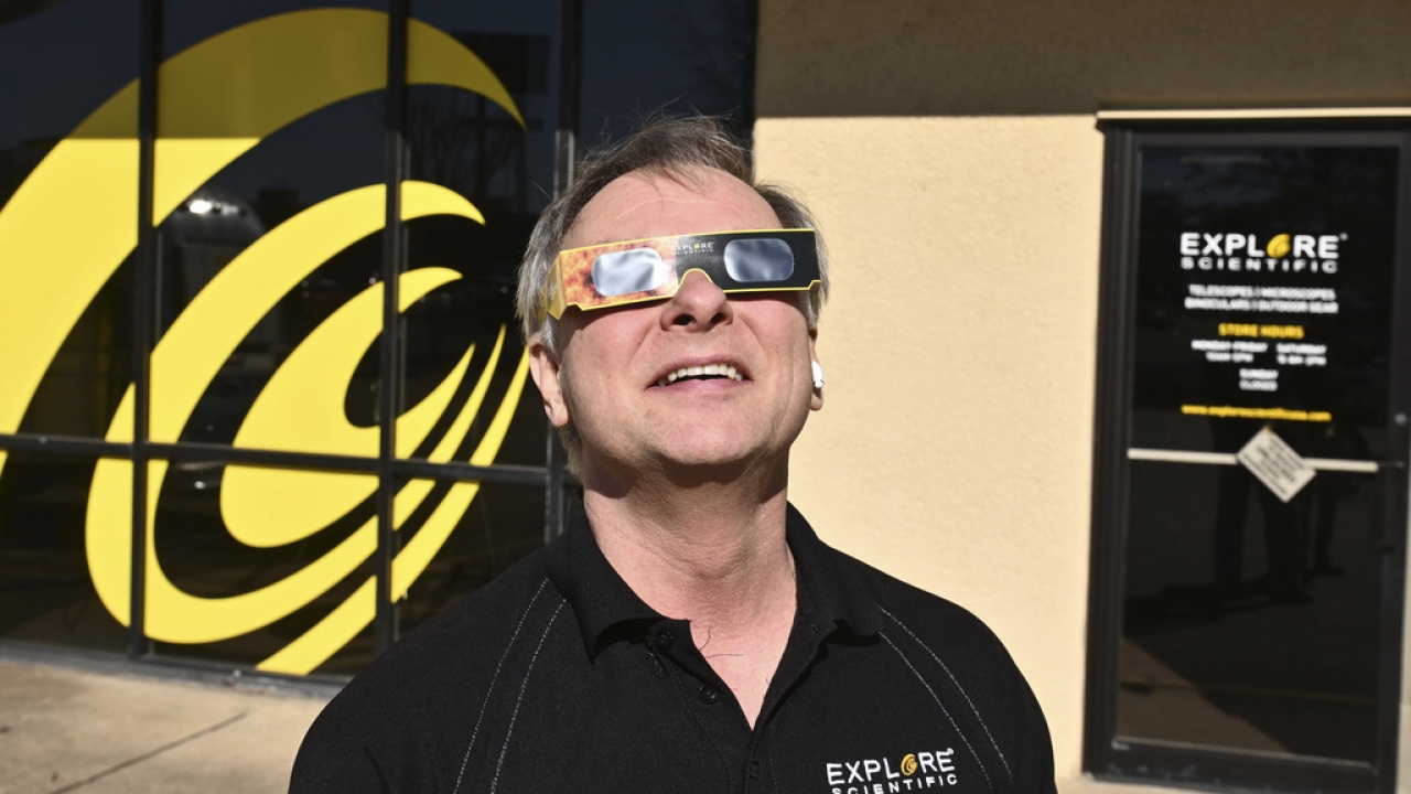 Scott Roberts, founder and president of Explore Scientific, shows a pair Sun Catcher solar eclipse glasses .