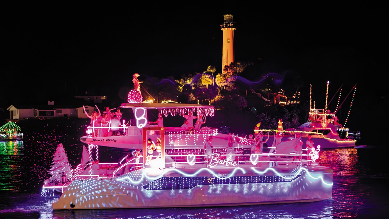 2023 'Barbie"-themed winner of the Palm Beach Holiday Boat Parade sails passed the Jupiter Lighthouse