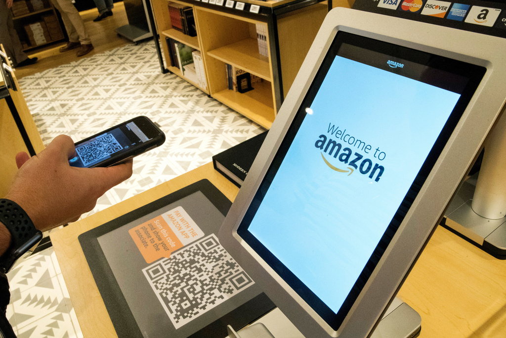 FILE - Daniel Thorpe, of Hoboken, N.J., uses the Amazon app to pay for his purchase at the Amazon 4-star store in the Soho neighborhood of New York