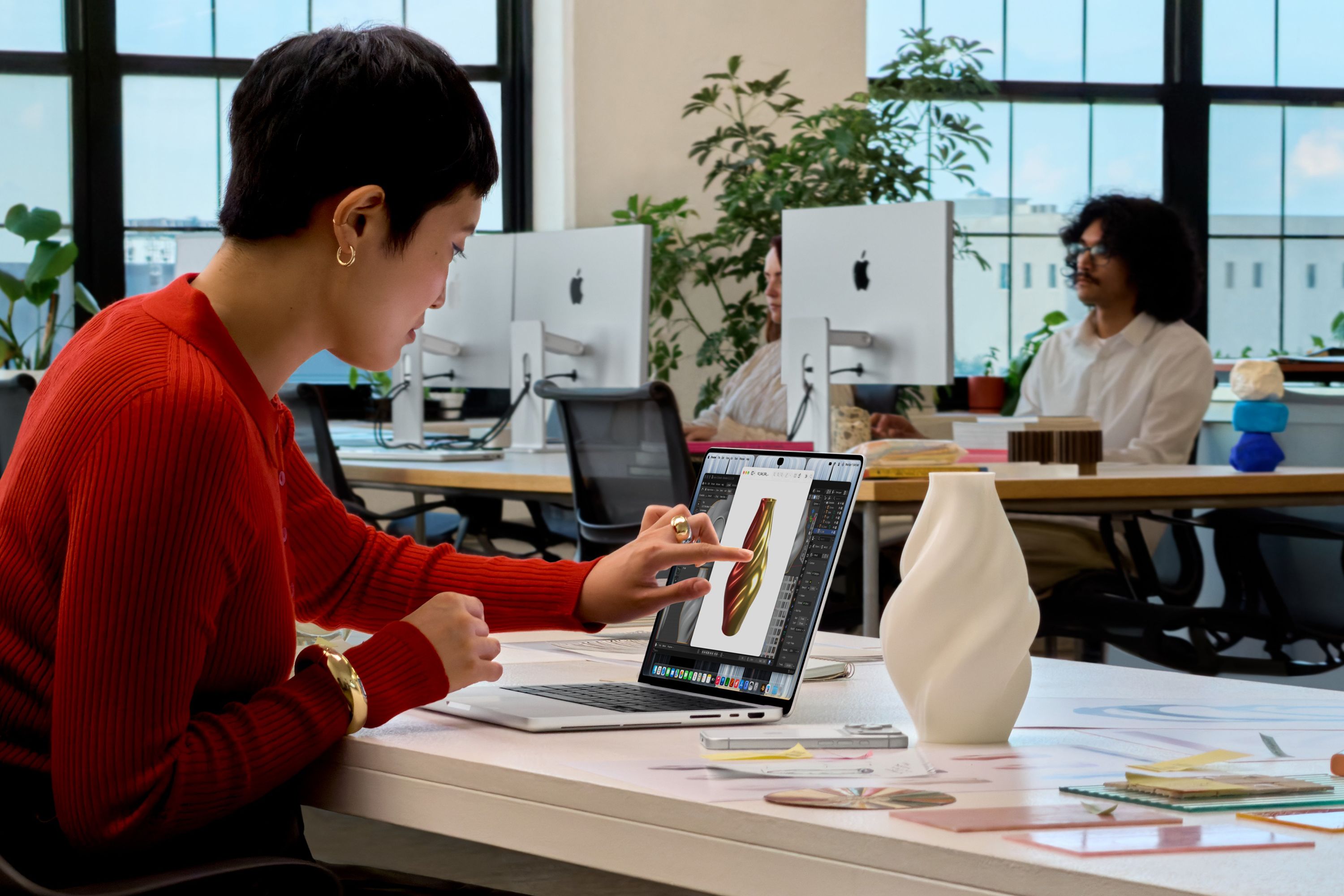 Person using touchscreen Macbook