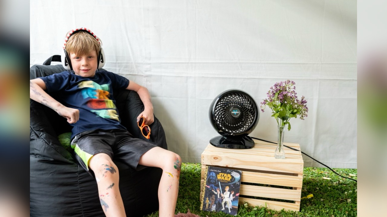 One child relaxing with his noise-canceling headphones