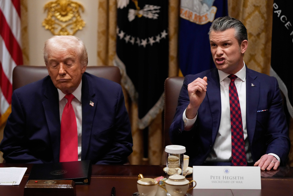 Defense Secretary Pete Hegseth speaks as President Donald Trump looks on, during a Cabinet meeting at the White House, Tuesday, Dec. 2, 2025, in Washington.
