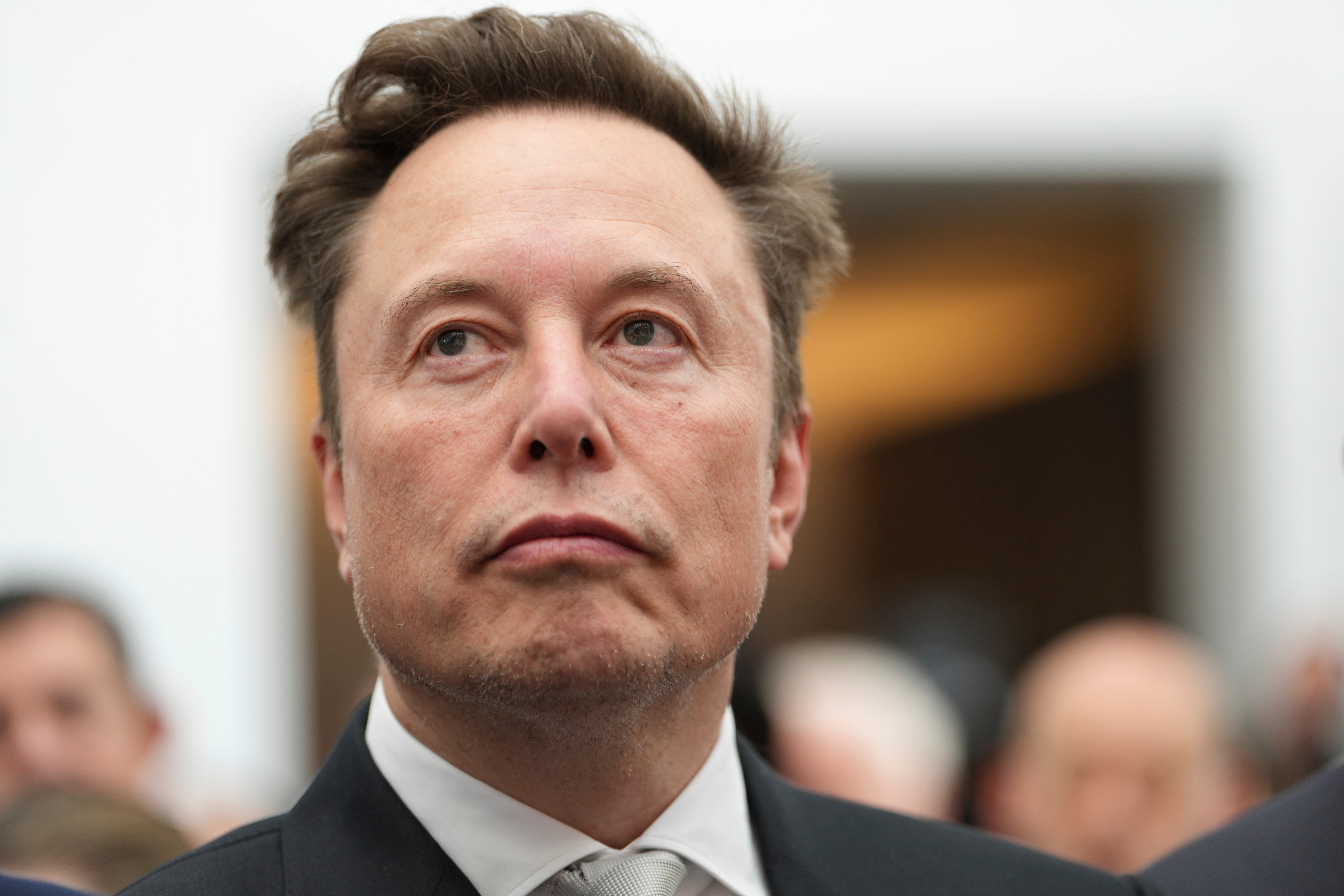 FILE - Elon Musk listens as President Donald Trump speaks during an event at the U.S. Institute of Peace, Oct. 8, 2026, in Washington.
