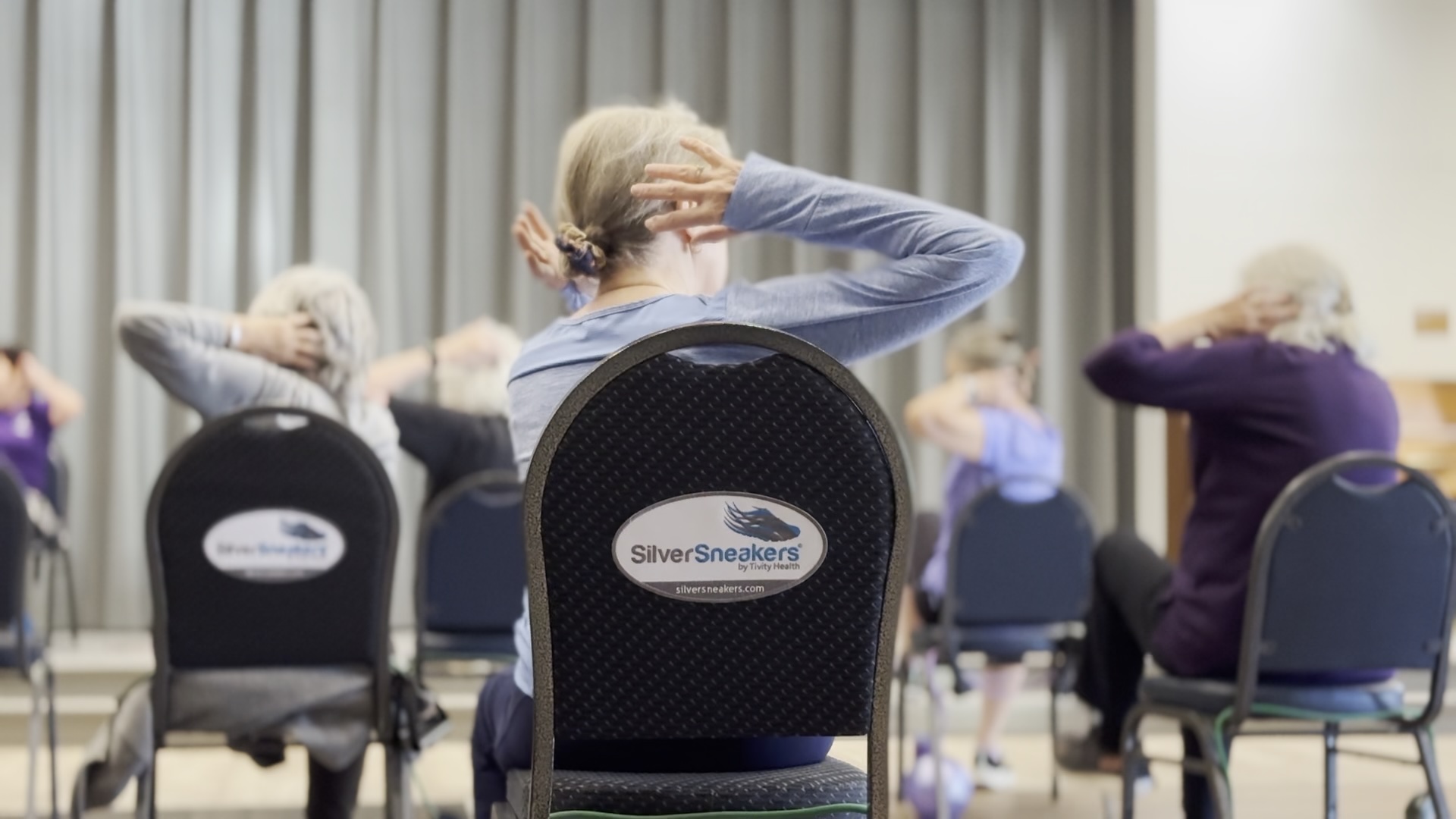 Seniors working out in SilverSneakers class