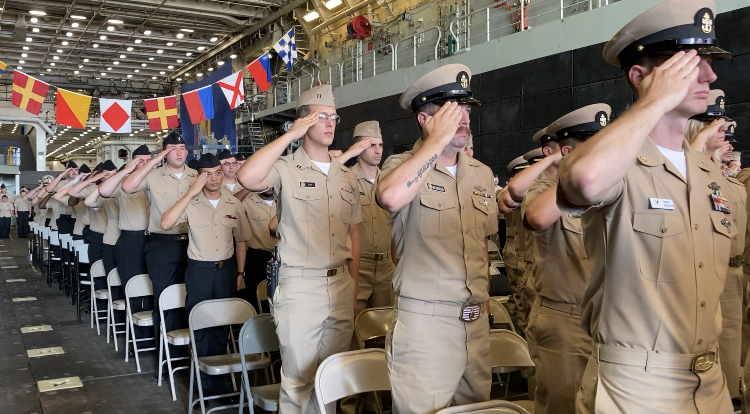 Sailors salute during National Anthem