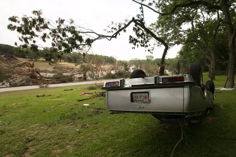 An overturned vehicle on the banks of the Blanco River on May 26, 2015, two days after catastrophic flooding in the Wimberley area.