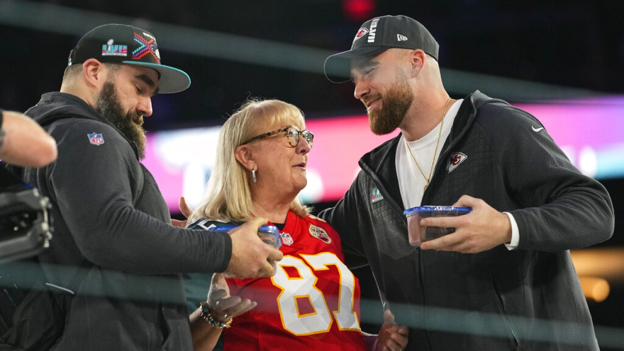 Donna Kelce greets her sons, Philadelphia Eagles center Jason Kelce, left, and Kansas City Chiefs tight end Travis Kelce.