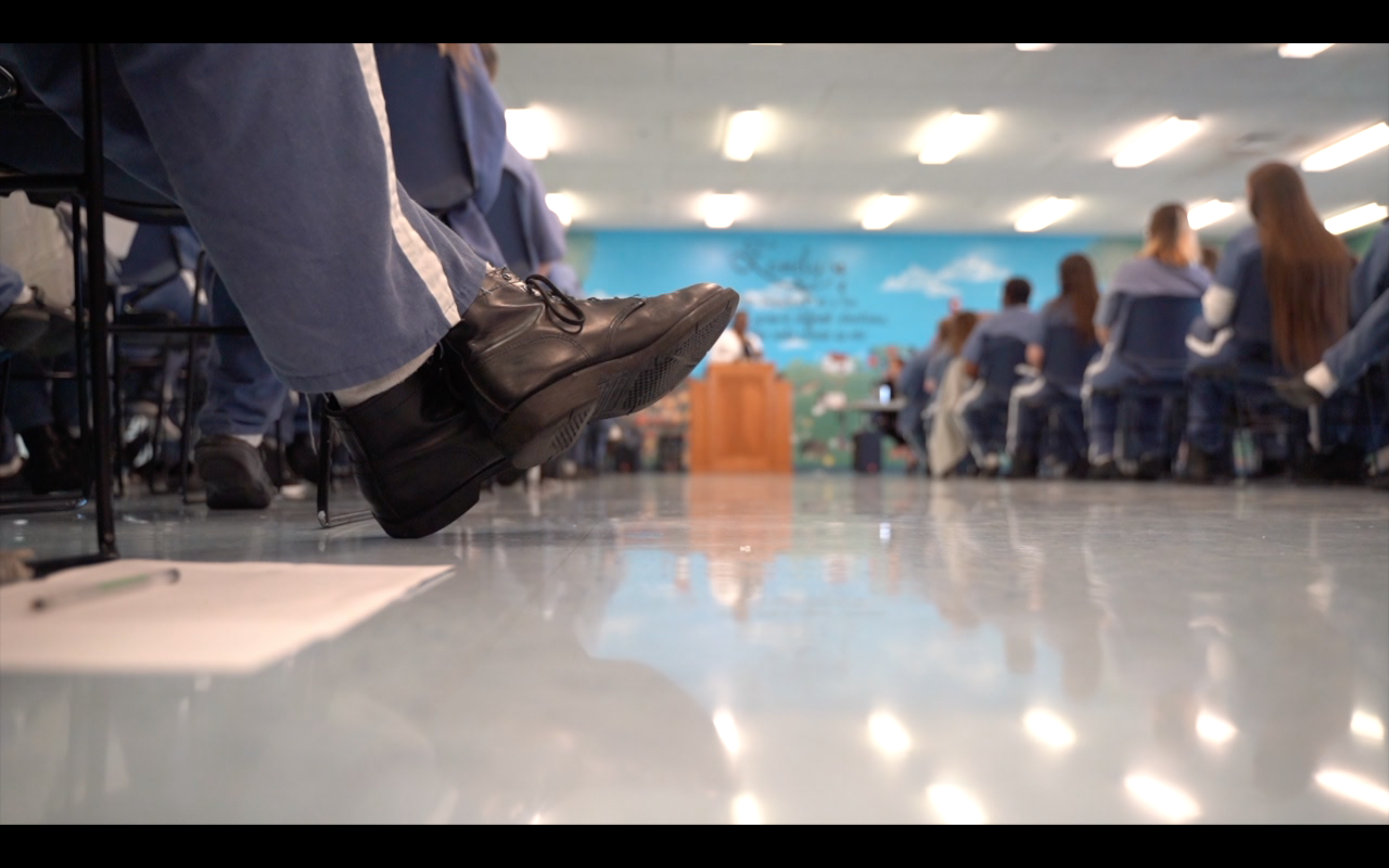 Female prisoners listen to a presentation on Human Trafficking