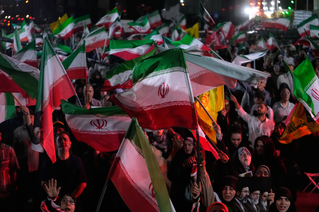 Pro-government demonstrators wave Iranian flags in a gathering at a square in Tehran, Iran, Friday, May 29, 2026. (AP Photo/Vahid Salemi)